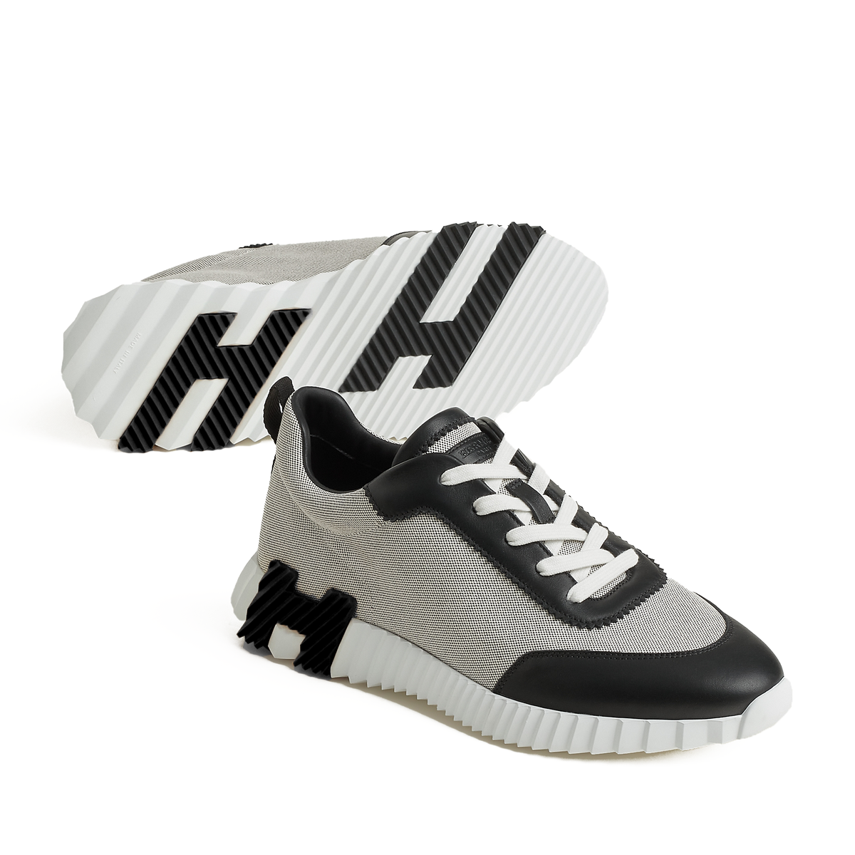 Hermes Bouncing sneakers featuring a light sole with a distinctive black H